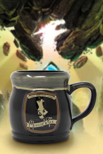 Image shows Dragon Age The Hanged Man Tavern Mug facing front. Product is a black mug and comes with a Hanged Man emblem, a glazed brim, and a C-shaped handle.