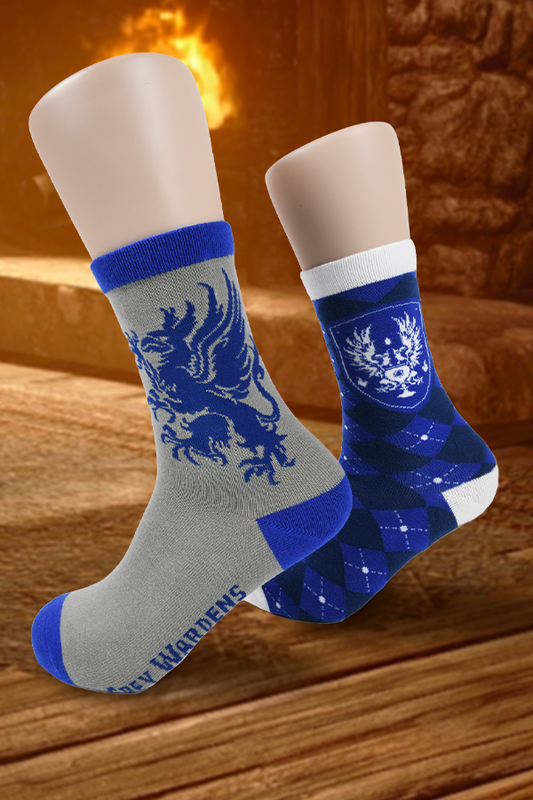 Image shows Dragon Age Grey Warden Sock Set worn on mannequin feet. Product set includes a pair of blue argyle socks and a pair of grey socks with the Grey Warden griffin insignia printed on the fabric.