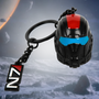 Image shows Mass Effect N7 Helmet Keychain facing front and with the N7 logo charm laid flat on the side. The 3D keychain is sculpted with zinc alloy and includes blue and red enamel accents; while the N7 keychain features white and red enamel filling. 